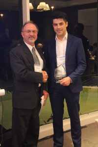 Manuel Lawrence accepts the award from ITEANZ President, Nick Szwed
