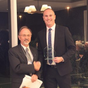 Andrew Parker accepts the award on behalf of Optus